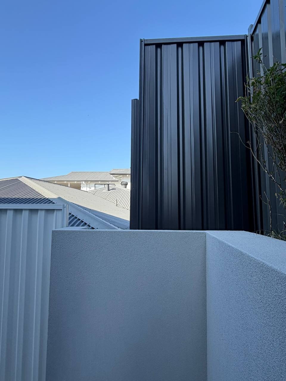 Black Colorbond over rendered wall