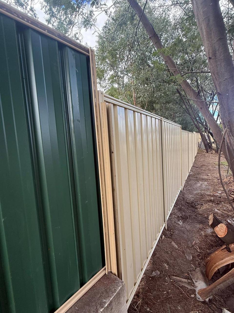 New Colorbond boundary fence, joined neatly to the existing fence