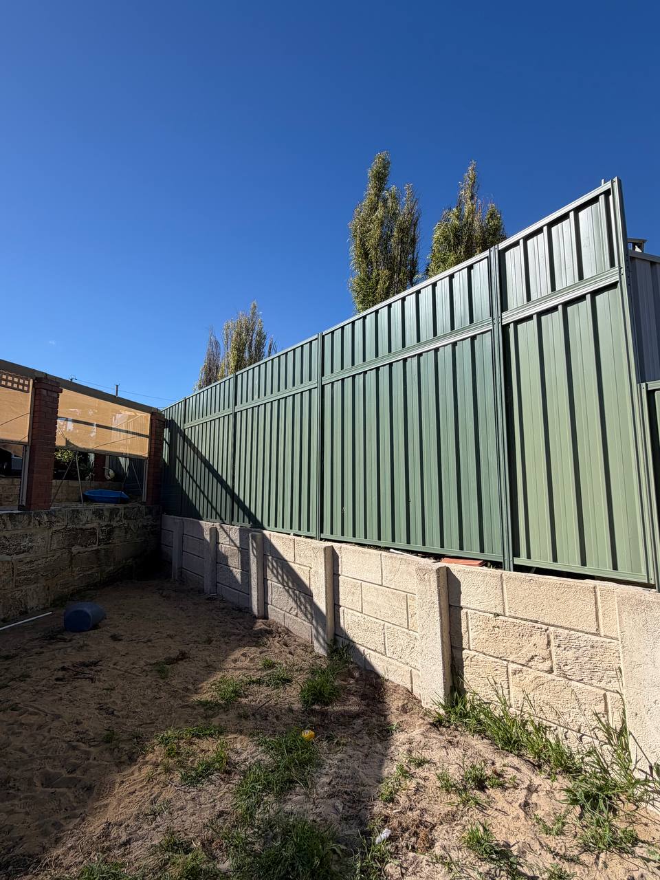 New Colorbond dividing fence with privacy extensions on the existing fence