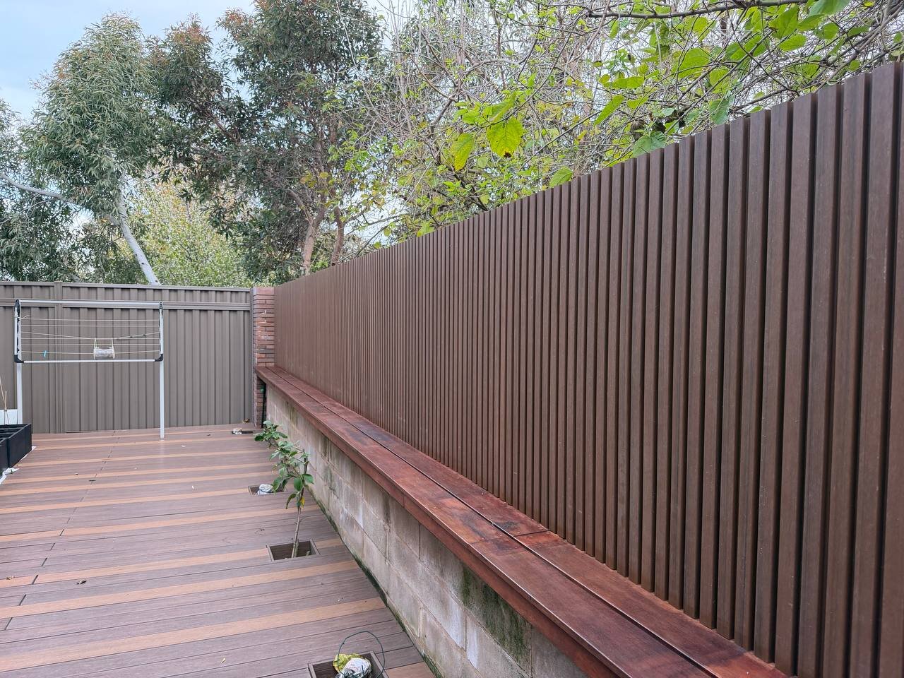 New slat fence along a deck