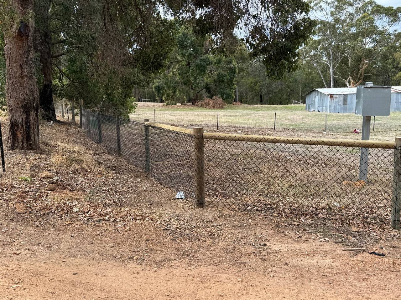 Chain-mesh stock fence along a rural paddock