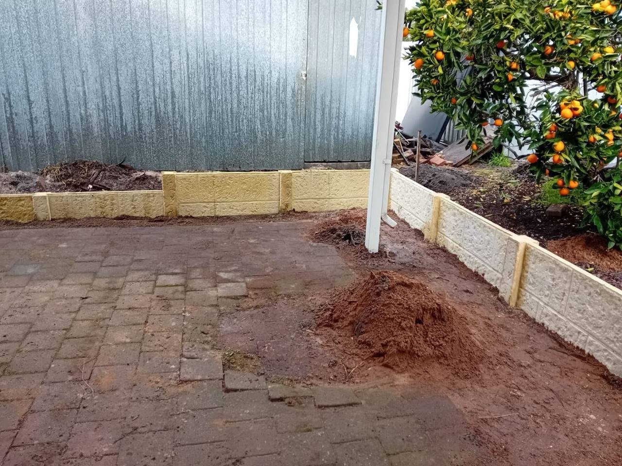 Work in progress: retaining wall around the paved area
