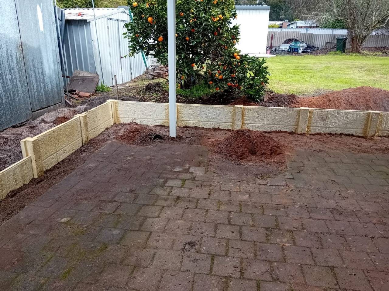 Work in progress: retaining wall corner around the paving
