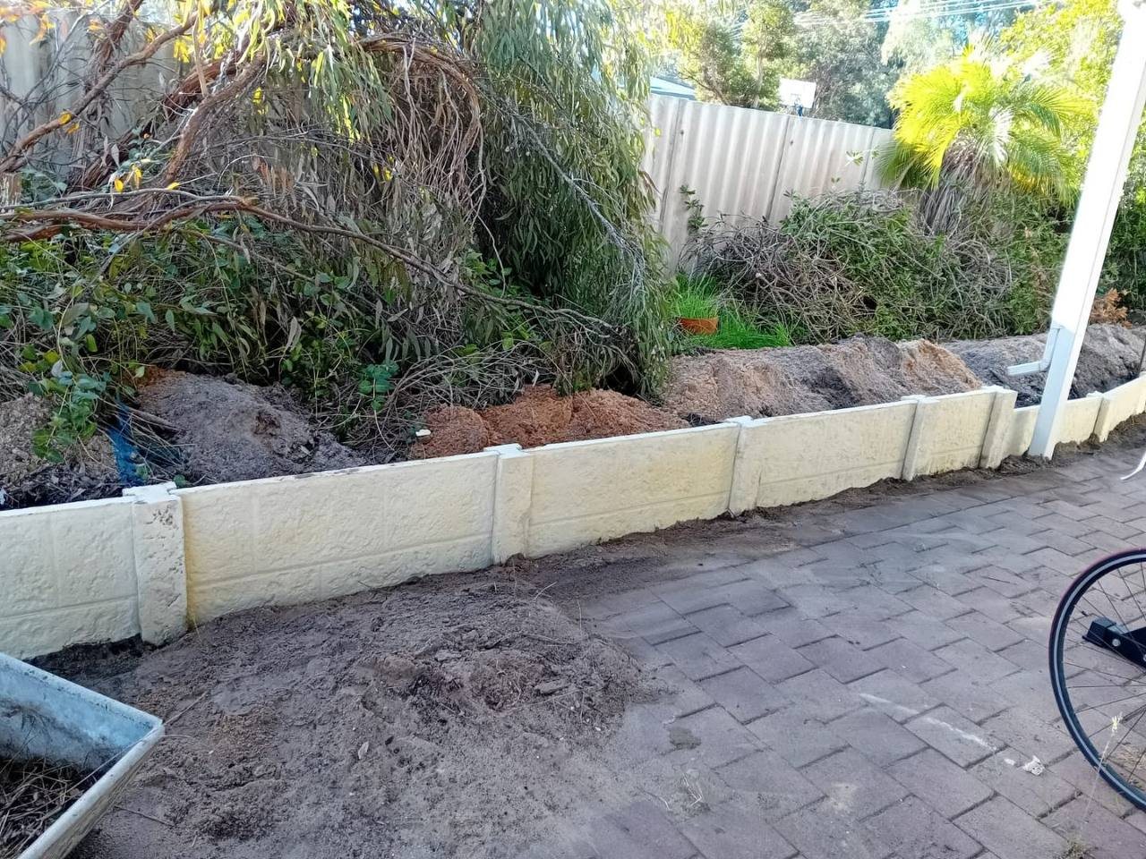 Work in progress: retaining wall finished along the garden bed
